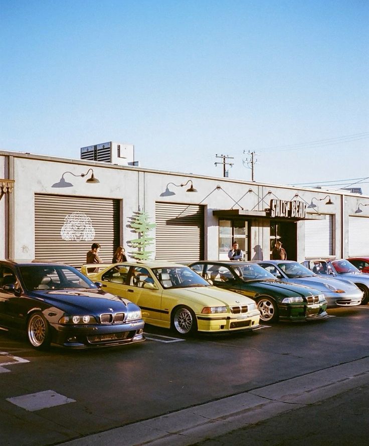 Row of cars parked outside a shop at a morning meet