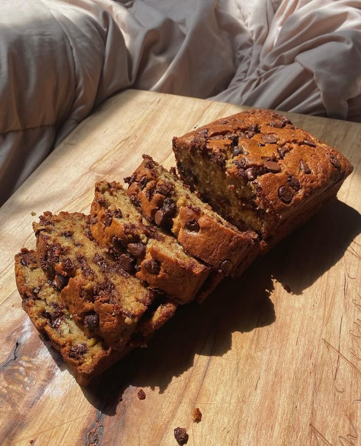 Sliced chocolate chip banana bread on a wood board
